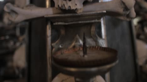 Panning-down-shot-over-human-skull---bones-remains-decorating-Sedlec-Ossuary-small-Roman-Catholic-chapel