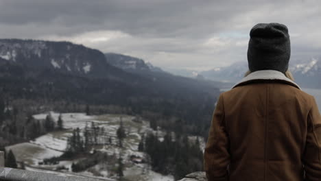 A-girl-gazes-out-at-a-gorge-from-a-scenic-viewpoint