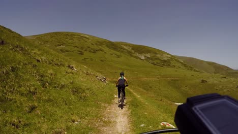 Girl-riding-bike-downhill-on-a-mountain