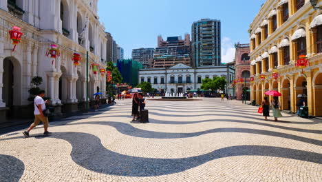 Macau-China---Circa-Time-lapse-of-people-walking-with-umbrellas-at-a-sunny-Senedo-Square-in-Macau,-China