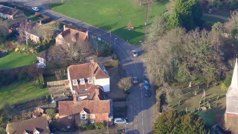 Aerial-tracking-shot-of-a-commuter-returning-home,-shot-in-High-Halden-village,-located-in-Kent-UK