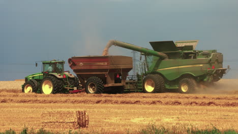 Tractor-and-combine-harvester-cutting-hay-in-late-summer