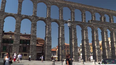 POV-view-walking-towards-ancient-aqueduct-watercourse-in-Segovia,-Spain-near-Madrid