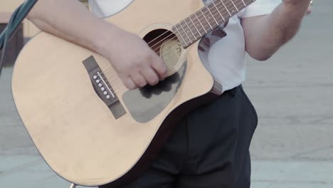 The-musician-plays-an-acoustic-guitar-on-the-street