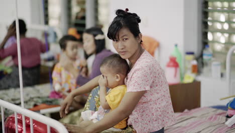 smiling-burmese-mother-with-her-child-looking-into-the-camera-showing-thumbs-up