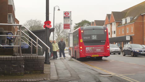 ZOOM-OUT-on-middle-class-English-people-waiting-at-a-bus-stop