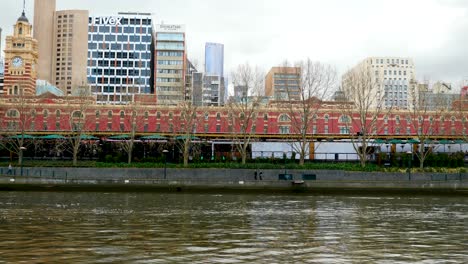 Melbourne-tourists-walking-yarra-riverside-walking-Queens-Bridge-in-daytime