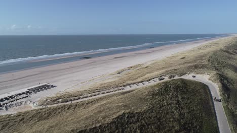 Dunes-in-the-netherlands-sky-view-drone-people-walking-on-the-beach