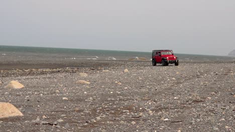 Jeep-Wrangler-crossing-a-creek-on-the-beach-on-Cooks-Inlet-on-the-Kenai-Peninsula-of-Alaska