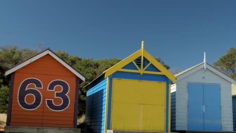 Tourists-walking-and-taking-photo-at-Brighton-Bathing-Boxes,-Melbourne,-Australia