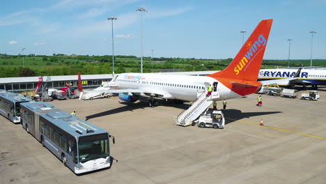 Tracking-shot-of-a-Sunwing-airplane-taxiing-to-its-arrival-terminal-gate