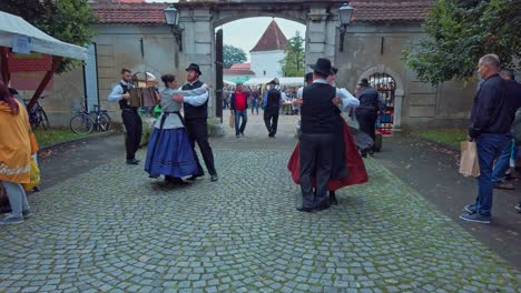 Folklore-dancers-performing-on-street-with-accordeon-player