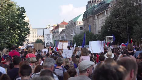 People-holding-transparents-at-demonstration-in-Prague,-Czech-Republic,-back-view