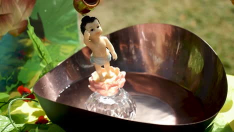 Water-Being-Poured-Over-A-Buddha-Statue