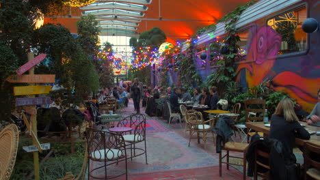 Steady-shot-of-people-eating-in-the-main-alley-of-the-Felicita-italian-food-market-in-Paris