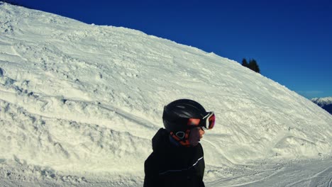 Teenage-boy-snowboarding-down-the-narrow-ski-run