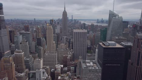 Establishing-shot-of-Midtown-Manhattan-tilting-up,-Empire-State-Building-in-the-middle,-filmed-from-Top-of-The-Rockefeller-Center