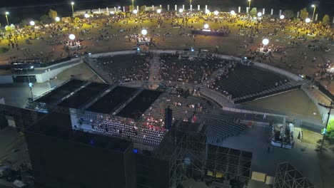 Aerial-drone-shot-of-a-nightly-live-event-at-a-park-stadium