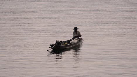 Fisherman-silhouetting-as-he-is-casting-and-drawing-his-net-in-the-River-before-dark