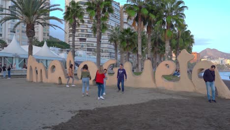 Famous-Malagueta-sign-with-tourists-on-it,-Malaga,-Spain,-steady-shot