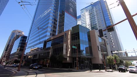 Time-Lapse-low-angle-traffic-moves-East-on-Washington-Street-at-the-intersection-of-Central-Avenue-where-the-Metro-light-rail-tracks-turn-North