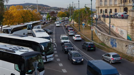 Cars-driving-in-traffic-jam-near-bus-station-in-city-of-Budapest,-Hungary