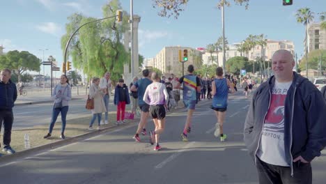 People-cheering-to-marathon-runners-in-Malaga,-Spain---wide-angle-shot