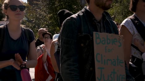 Queens-Park,-Toronto---Couples-with-babies-and-the-crowd-are-going-for-the-Climate-Change-Campaign---close-up