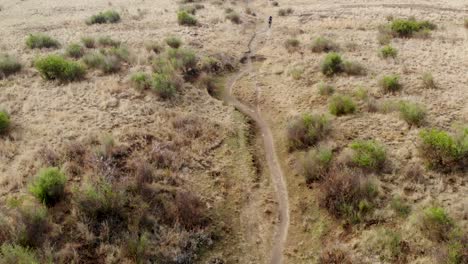 aerial-following-mountain-bikers-on-a-single-track-in-slow-motion