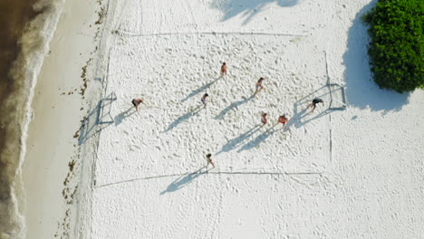 people-on-Cancun-beach-playing-soccer-next-to-the-beach-and-resort,-with-white-sand