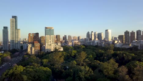 Aerial-lowering-shot-of-Plaza-Sicilia-and-Palermo-skyline-at-golden-hour,-Buenos-Aires