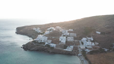Drone-aerial-flight-towards-small-housing-community-at-the-island-of-Tinos-in-Greece