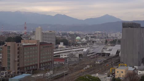 Japan---Train-Passing-In-The-Urban-Train-Station-Over-The-Railways-In-Slow-Motion---Aerial-Shot