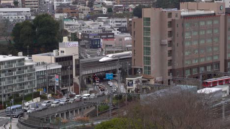 Bullet-Train-Slows-Down-To-Stop-at-Train-Station-In-Japan---wide-shot