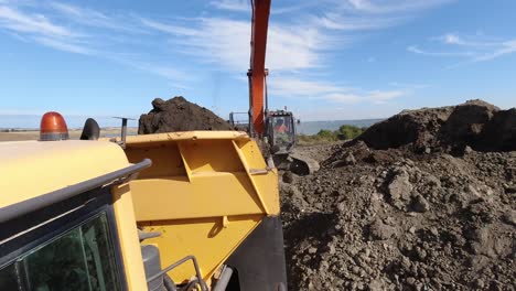 Action-cam-time-lapse-shot-of-a-dumper-truck-being-loaded-on-a-construction-site