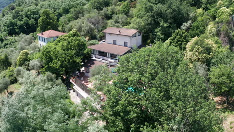 Wide-aerial-dolly-of-Mediterranean-villa-in-woodlands
