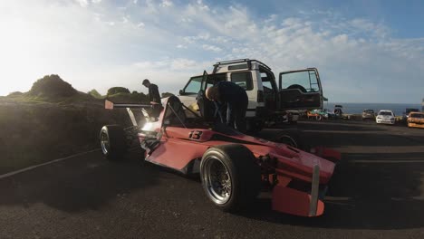 Man-Refuelling-The-Racing-Car-Parked-At-The-Roadside-On-The-Hill-In-Imtahleb-Malta-On-A-Bright-Sunny-Weather---GoPro-Pan-Shot