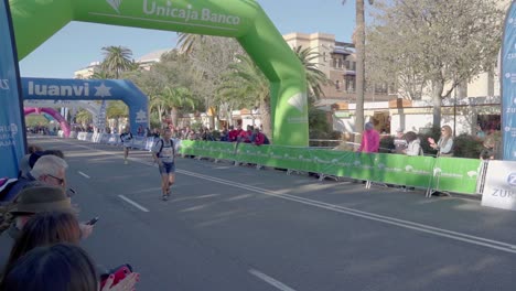 Runners-of-Zurich-Marathon-Malaga-in-Spain-approaching-finishing-line,-slow-mo