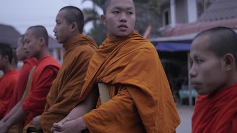 Young-monks-morning-alms-chanting-preparation-for-religious-food-offering-donation-ceremony-Sai-Bat