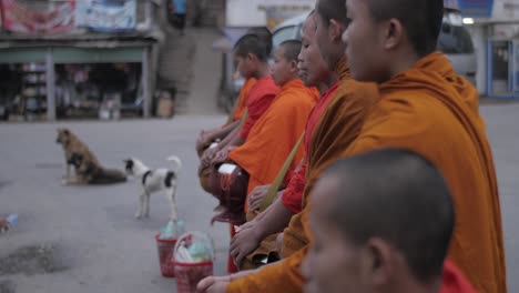 Young-monks-morning-alms-chanting-in-village-religious-food-offering-donation-ceremony-Sai-Bat