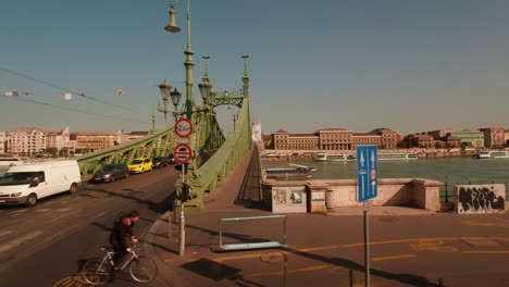 Green-metal-bridge-over-river-Danube-in-city-of-Budapest-Hungary