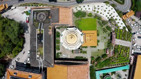 Kek-Lok-Si-Buddhist-temple-pagoda-shrine-roof-spires-are-seen-from-above,-Aerial-drone-top-view-lift-shot