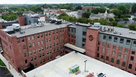 Aerial-of-Hilton-Hotel-in-Lititz-PA,-converted-old-brick-factory-building