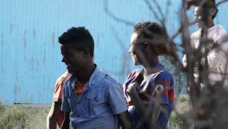 Medium,-slow-motion-shot-of-happy-teenagers-outside-school-in-Ziway,-Ethiopia