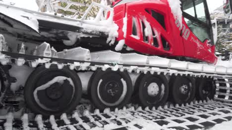 Pan-shot-of-the-machinery-of-a-snow-plow-in-a-ski-resort