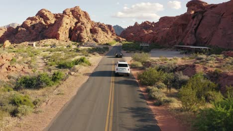 Rolls-Royce-and-Ferrari-on-the-open-road-in-the-Valley-of-Fire,-Nevada