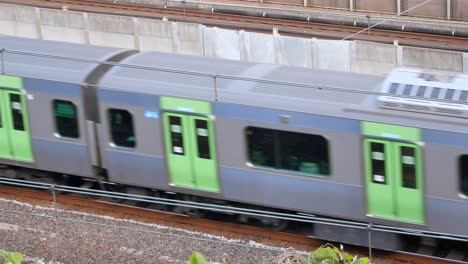 Toyko,Japan-:-POV-zoom-into-train-railway-while-train-is-passing-in-daytime