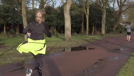 Active-fitness-group-jogging-running-and-walking-in-wet-rainy-park-in-slow-motion