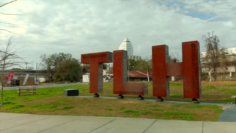 Aerial-View-of-TLH-Statue-With-Buildings-in-Background-in-Tallahassee,-Florida-USA