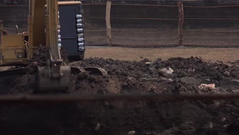 Medium-Exterior-Shot-of-a-Digger-Scooping-up-the-Earth-on-a-Building-Site